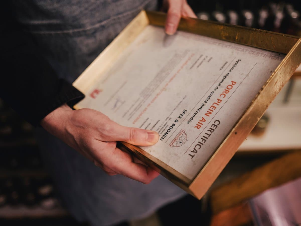 Bjorn with the paper certificate in the shop.