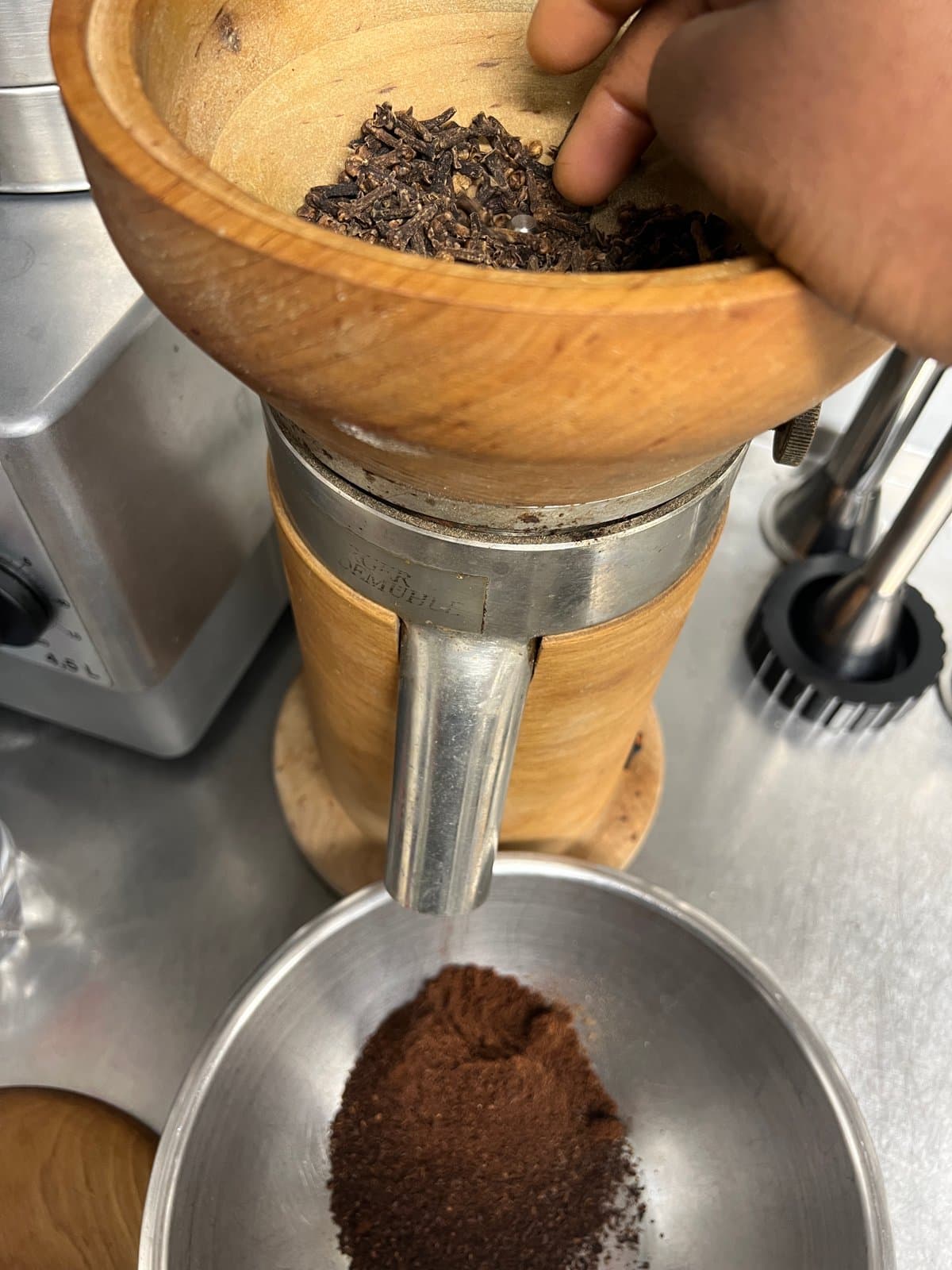 Whole cloves going through the stone mill